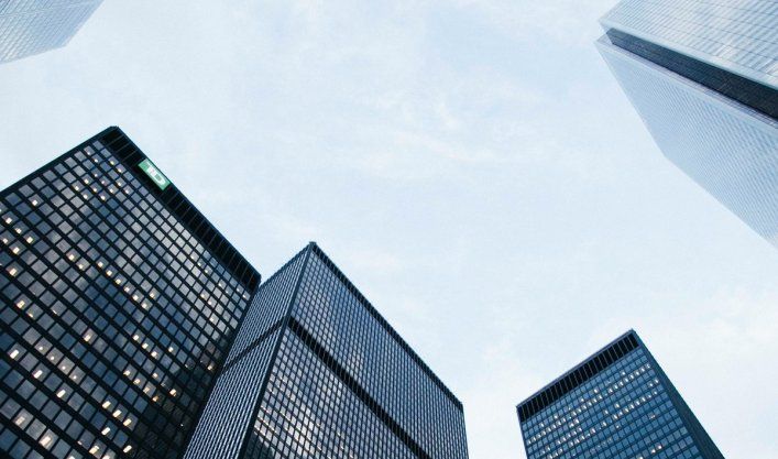 Glass facades of office towers in a financial district, symbolising a learning platform for the banking sector