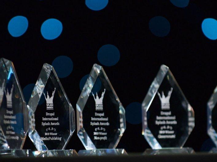 Mehrere gläserne Splash-Award-Trophäen in einer Reihe stehend