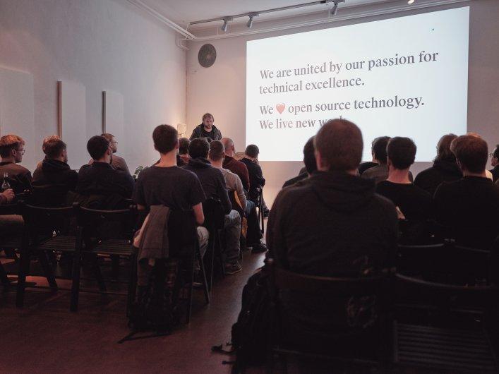 Slide: We are united by our passion for technical excellence. We love open source technology. We live new work