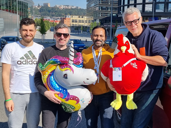 Image showing the Factorial team at DrupalCon Prague 2022, holding the Lille rooster mascot.